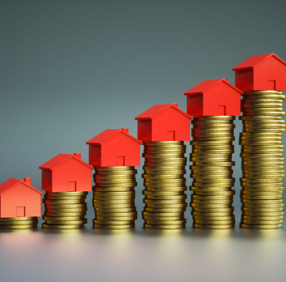 Houses on stack of coins Houses on stack of coins